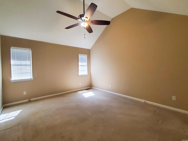 empty room featuring ceiling fan, baseboards, and high vaulted ceiling