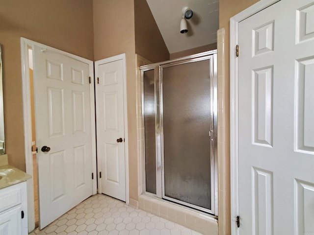 bathroom featuring a stall shower, vanity, and tile patterned flooring