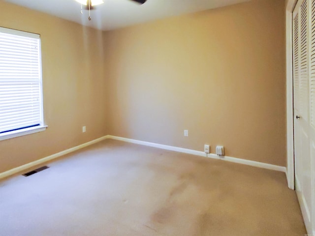 unfurnished bedroom with carpet, visible vents, a closet, and baseboards