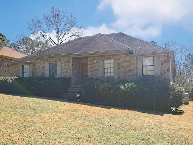 ranch-style house with brick siding and a front yard