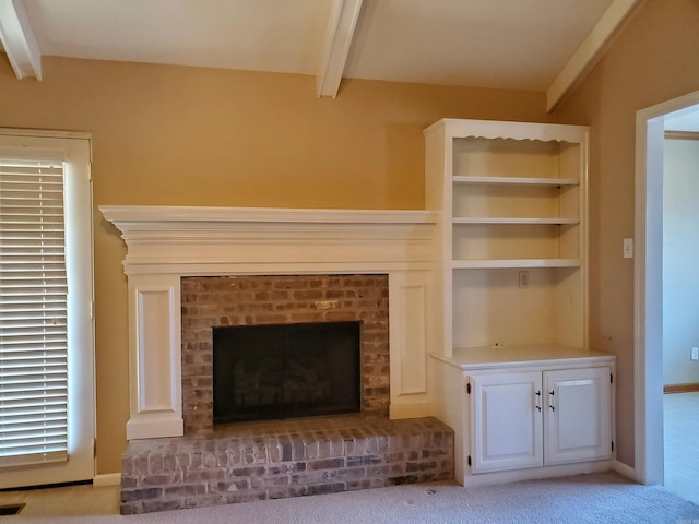 unfurnished living room with visible vents, beamed ceiling, a fireplace, and light colored carpet