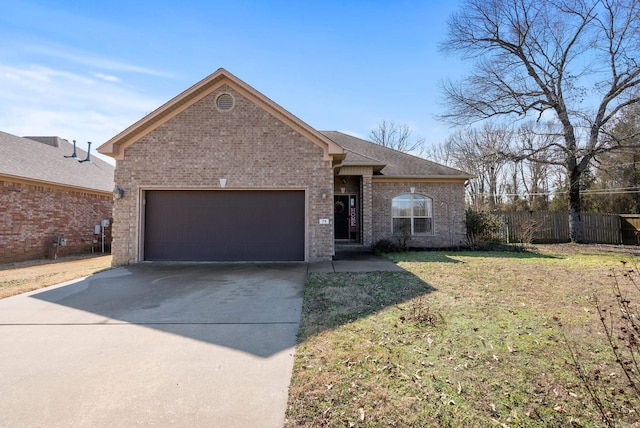 single story home featuring driveway, fence, a front yard, an attached garage, and brick siding