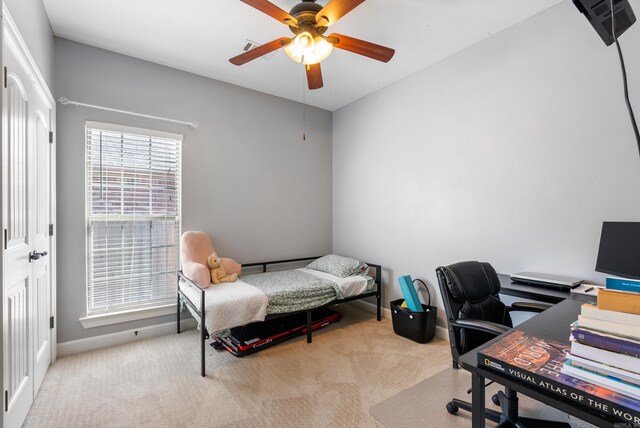 carpeted bedroom featuring baseboards and ceiling fan