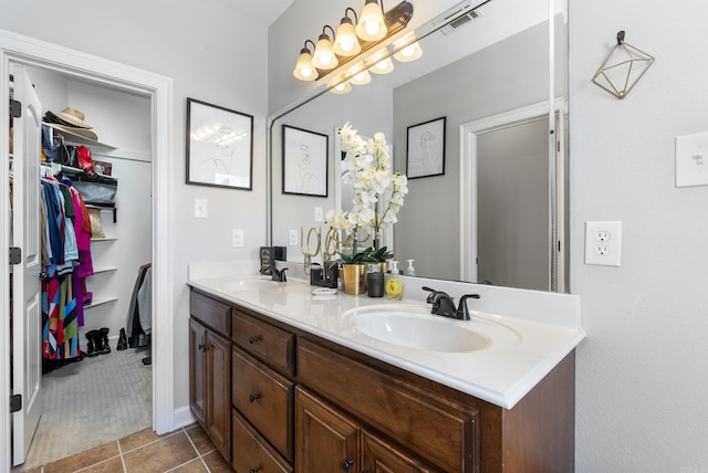 full bathroom with tile patterned flooring, double vanity, visible vents, and a sink