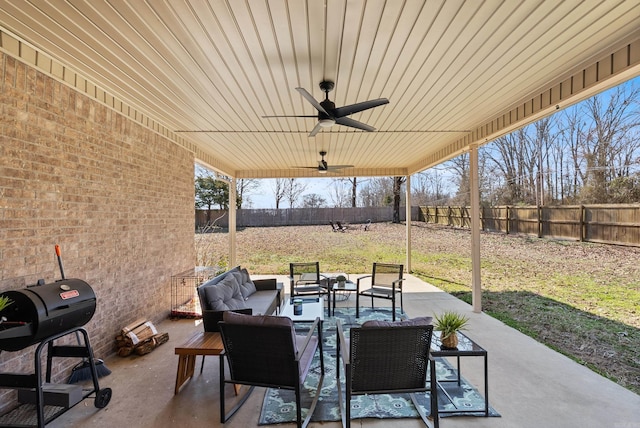 view of patio featuring area for grilling, ceiling fan, an outdoor hangout area, and a fenced backyard