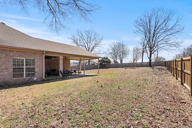 view of yard with a patio area, ceiling fan, and a fenced backyard