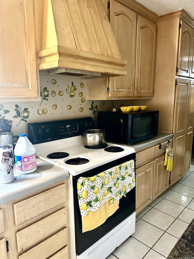 kitchen with premium range hood, range with electric stovetop, light tile patterned flooring, black microwave, and light countertops