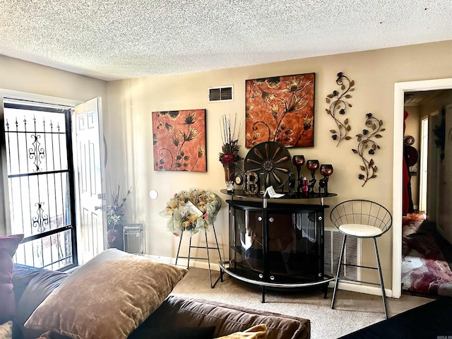 living room with a wealth of natural light, visible vents, and carpet floors