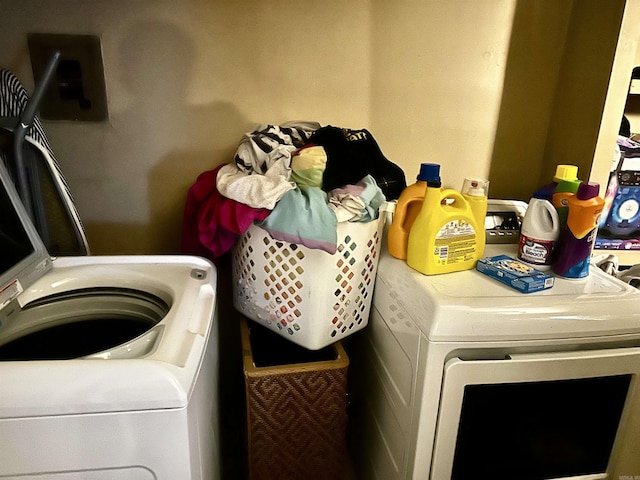 clothes washing area featuring laundry area and separate washer and dryer