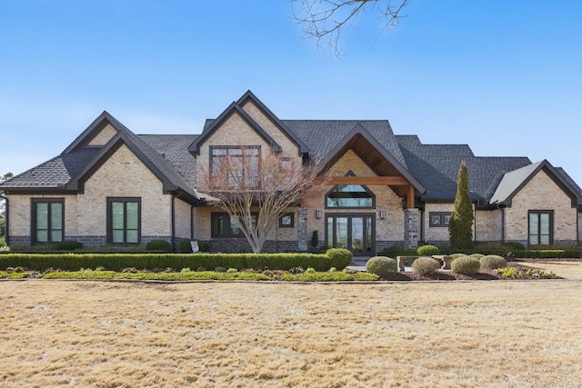 view of front of home featuring french doors and brick siding