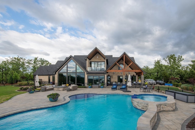 view of swimming pool featuring a patio, fence, an outdoor living space, and a pool with connected hot tub