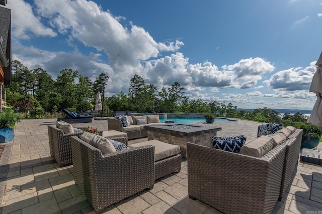 view of patio / terrace featuring an outdoor pool, outdoor lounge area, and an in ground hot tub