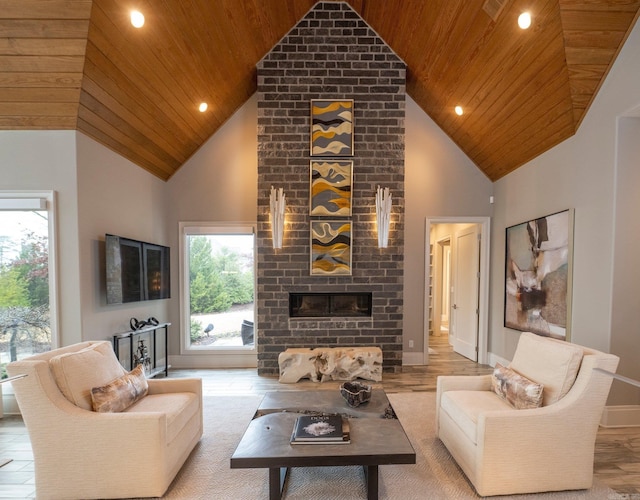 living area featuring wood ceiling, baseboards, high vaulted ceiling, and a brick fireplace