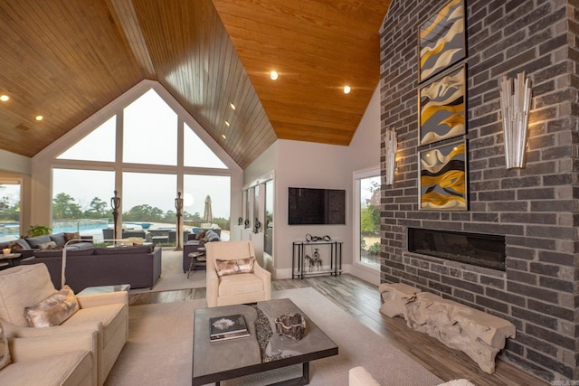 living area featuring a brick fireplace, recessed lighting, wooden ceiling, wood finished floors, and high vaulted ceiling