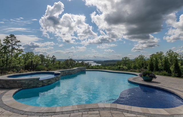 view of swimming pool featuring a pool with connected hot tub