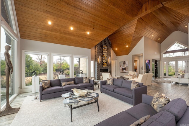 living room featuring hardwood / wood-style floors, high vaulted ceiling, a healthy amount of sunlight, and wooden ceiling