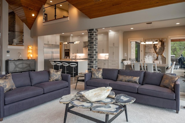 living area with visible vents, ornate columns, high vaulted ceiling, recessed lighting, and wooden ceiling