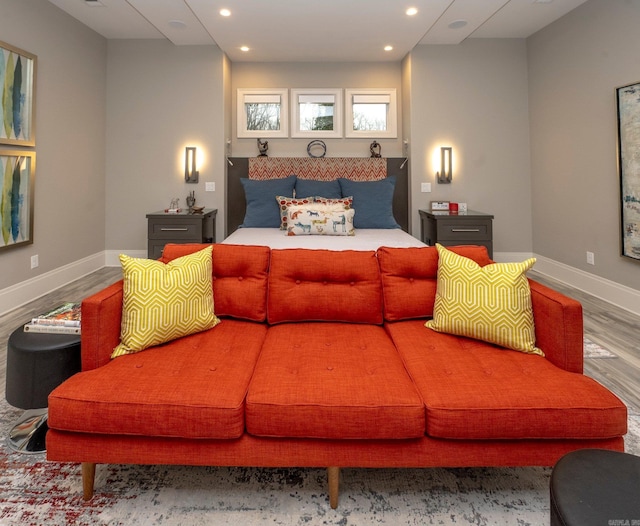 bedroom with wood finished floors, recessed lighting, and baseboards