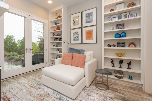 living area featuring recessed lighting, french doors, and wood finished floors