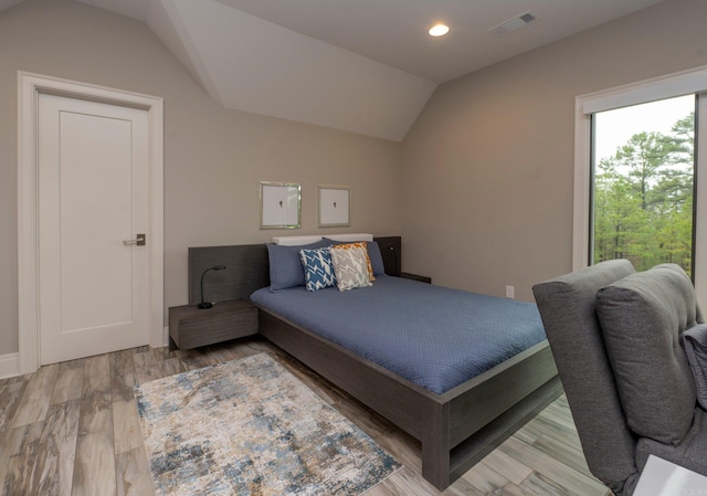 bedroom featuring visible vents, recessed lighting, wood finished floors, and vaulted ceiling