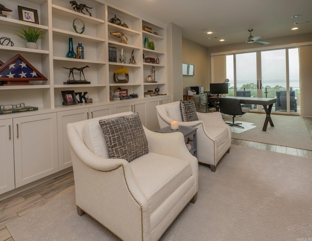 living area featuring recessed lighting, light wood-type flooring, and a ceiling fan