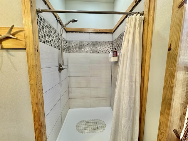 bathroom with a tile shower