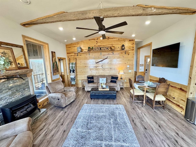 living room featuring wood finished floors, lofted ceiling with beams, recessed lighting, ceiling fan, and wood walls