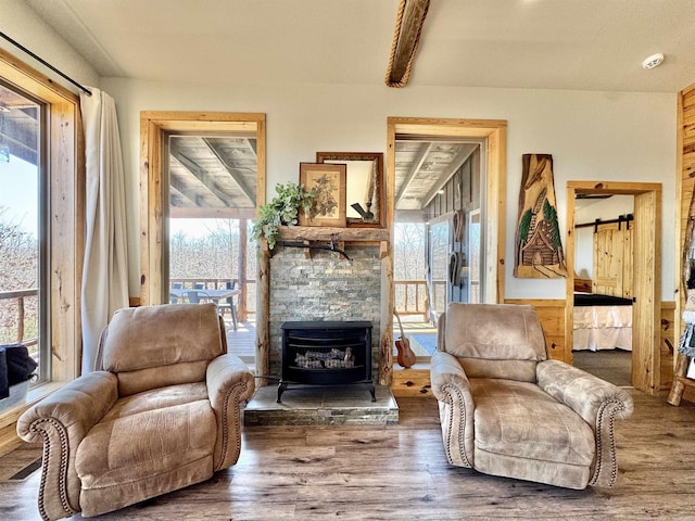 living area with beam ceiling and wood finished floors