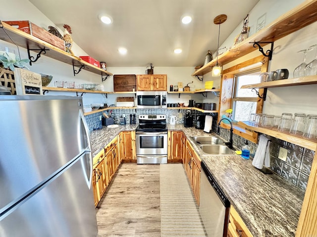 kitchen featuring open shelves, a sink, recessed lighting, stainless steel appliances, and brown cabinetry