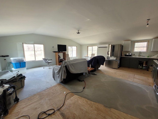 living area with unfinished concrete floors and vaulted ceiling