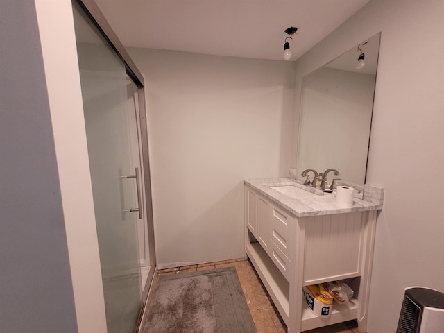 bathroom featuring a stall shower and vanity