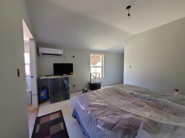 bedroom with vaulted ceiling and a wall mounted AC