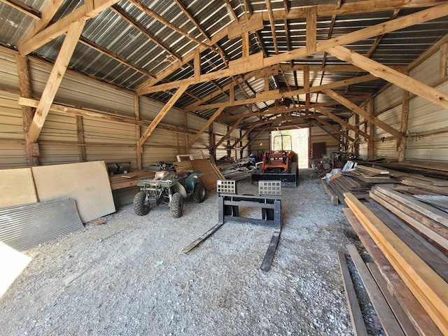 miscellaneous room with lofted ceiling and metal wall