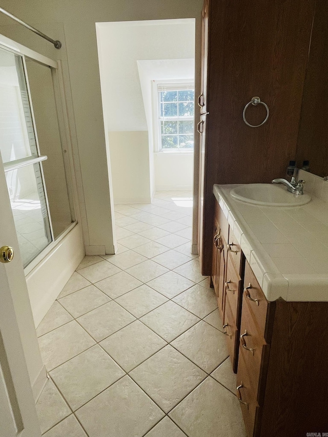 full bath with tile patterned floors, shower / bath combination with glass door, and vanity