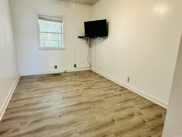 interior space with baseboards and wood finished floors