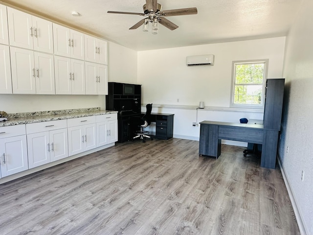 office with ceiling fan, baseboards, light wood-type flooring, and a wall mounted AC