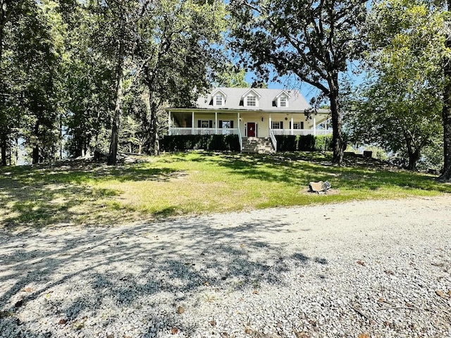 view of front of house with covered porch and a front lawn