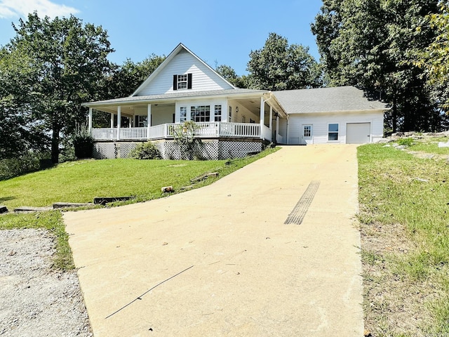 farmhouse-style home with an outbuilding, a front yard, driveway, a porch, and a garage