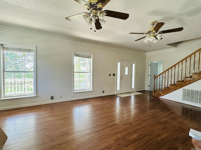 entrance foyer featuring stairs, plenty of natural light, wood finished floors, and visible vents