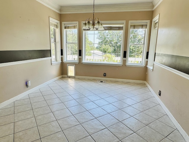 unfurnished dining area featuring a healthy amount of sunlight, ornamental molding, light tile patterned flooring, and an inviting chandelier