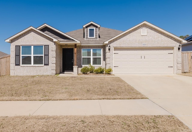 view of front of house with a garage, brick siding, and driveway