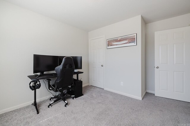 carpeted home office with baseboards