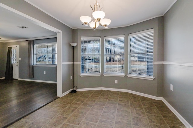 unfurnished dining area with crown molding, visible vents, baseboards, and a chandelier