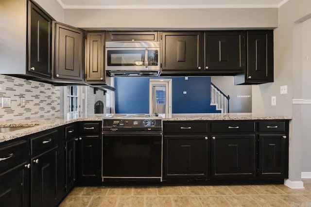 kitchen with a peninsula, electric range, ornamental molding, decorative backsplash, and stainless steel microwave