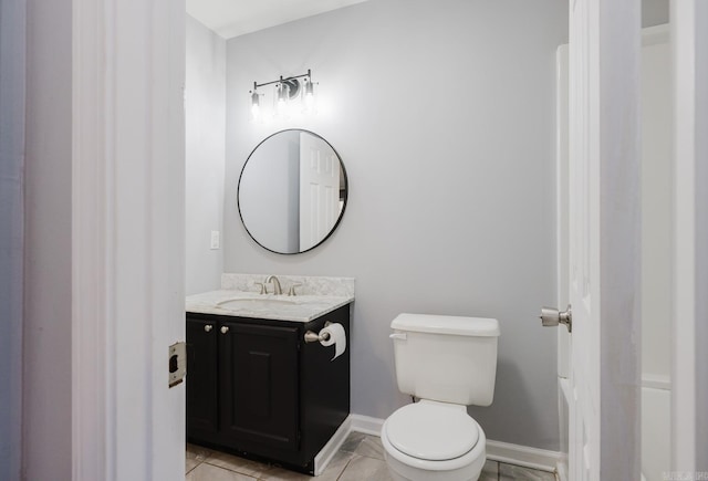 half bathroom with vanity, toilet, and baseboards