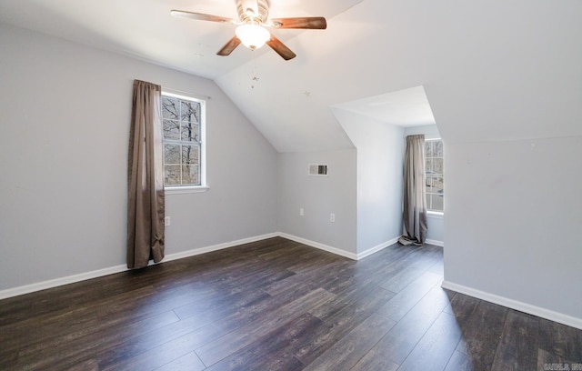 bonus room featuring visible vents, baseboards, dark wood finished floors, vaulted ceiling, and a ceiling fan