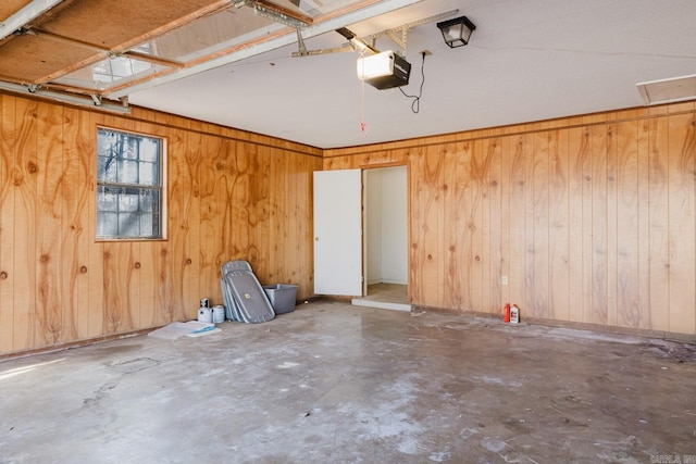 garage with wooden walls and a garage door opener