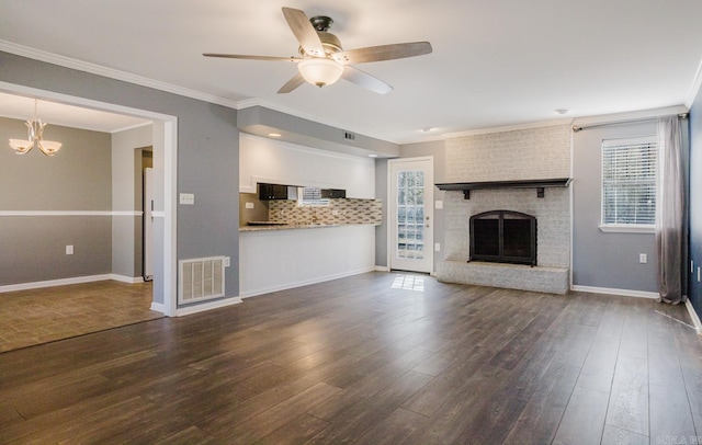 unfurnished living room with visible vents, a fireplace, dark wood-style flooring, and crown molding