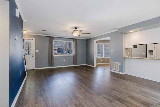 unfurnished living room featuring visible vents, ornamental molding, baseboards, ceiling fan, and dark wood-style flooring