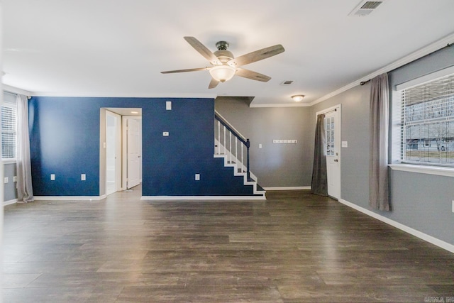 interior space featuring wood finished floors, baseboards, visible vents, ornamental molding, and stairs